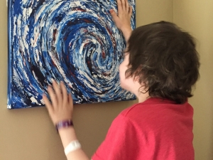 cancer survivor playing with Anne's art